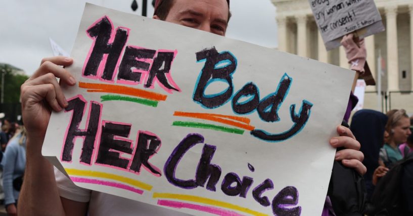 A pro-abortion protester stands outside the Supreme Court on May 14, 2022.