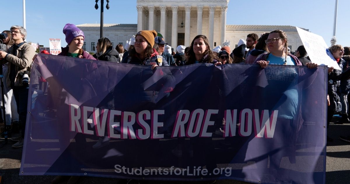 Pro-Life protesters stand outside the U.S. Supreme Court on Dec. 1, 2021 as the court prepares to hears a case over a 2018 Mississippi law banning abortions after 15 weeks.