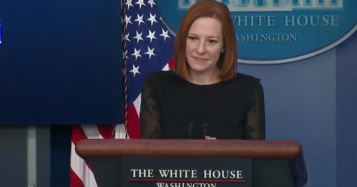 White House press secretary Jen Psaki tries to put on a brave face while listening to a reporter detail the failures of the Biden administration's first year.