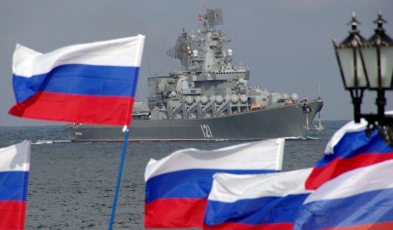 Russian flags fly as a missile cruiser enters Sevastopol, Russia, on Sept. 10, 2008.