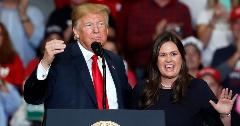 Former White House press secretary Sarah Huckabee Sanders, right, is pictured with then-President Donald Trump in this file photo from November 2018. Sanders is now running for Arkansas governor and has far more campaign contributions than any of her competitors.