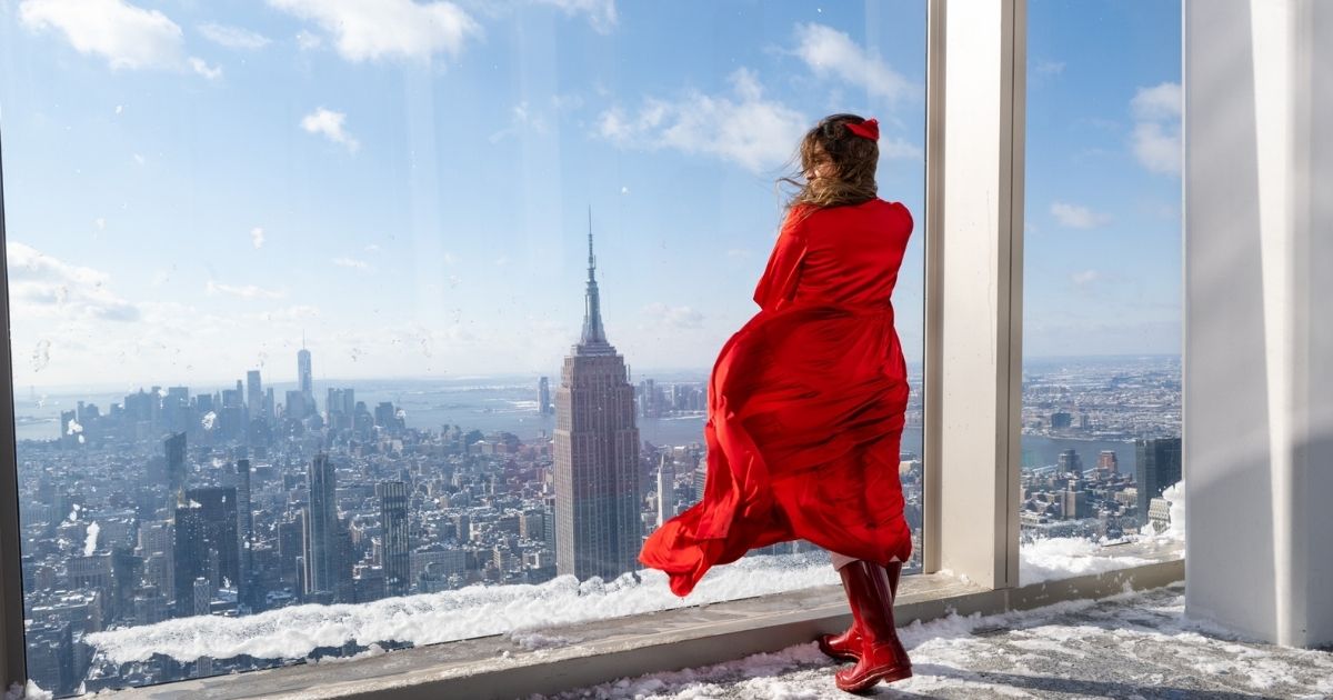 Cidra Shamsi, 30, of India, visits Summit One Vanderbilt during the first snowstorm of the season with the Empire State Building in the background on Friday, Jan. 7, in New York City.