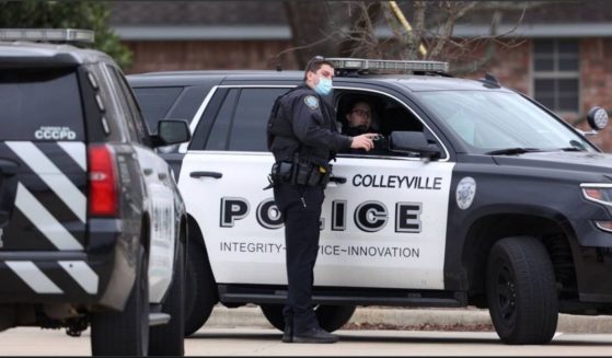 Colleyville police sit outside the Congregation Beth Israel in Colleyville, Texas, on Saturday after a man took hostages and demanded the release of a terrorist.
