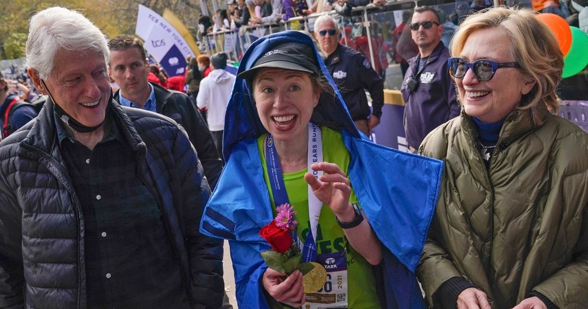 Bill and Hillary Clinton walk with their daughter, Chelsea Clinton, center, after she completed the New York City Marathon in November. The Clintons appear to be testing the waters for a return to active political life.