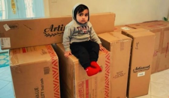 Ayaansh Kumar, a 22-month-old from Middlesex Count, New Jersey, sits atop the merchandise he ordered using his mom's phone.