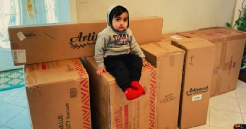 Ayaansh Kumar, a 22-month-old from Middlesex Count, New Jersey, sits atop the merchandise he ordered using his mom's phone.