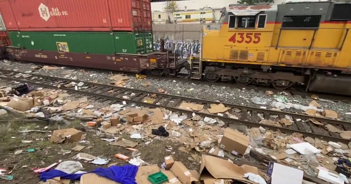 A Union Pacific train passes by an area littered with stolen packages. Rail thefts have increased 160 percent in Los Angeles County over the past year, and railroad officials believe the increase is due to the LA County District Attorney’s policy of not prosecuting low-level crimes