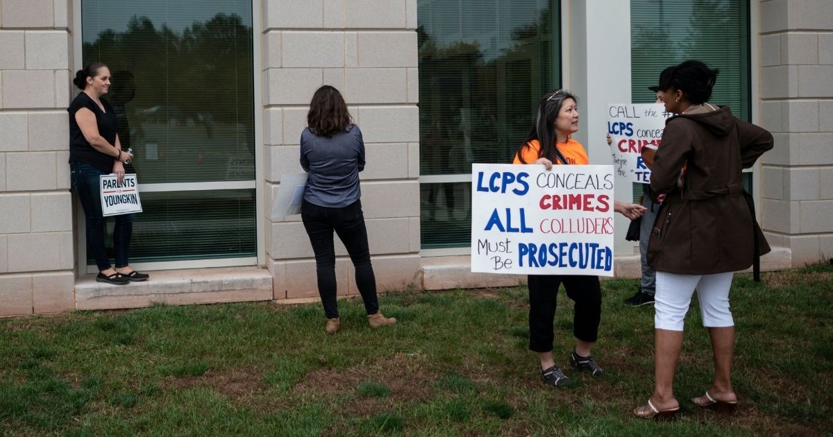 Protesters demonstrate outside a Loudoun County, Virginia, school board meeting in October to publicize the school district's handling of a sexual assault case that made national headlines.