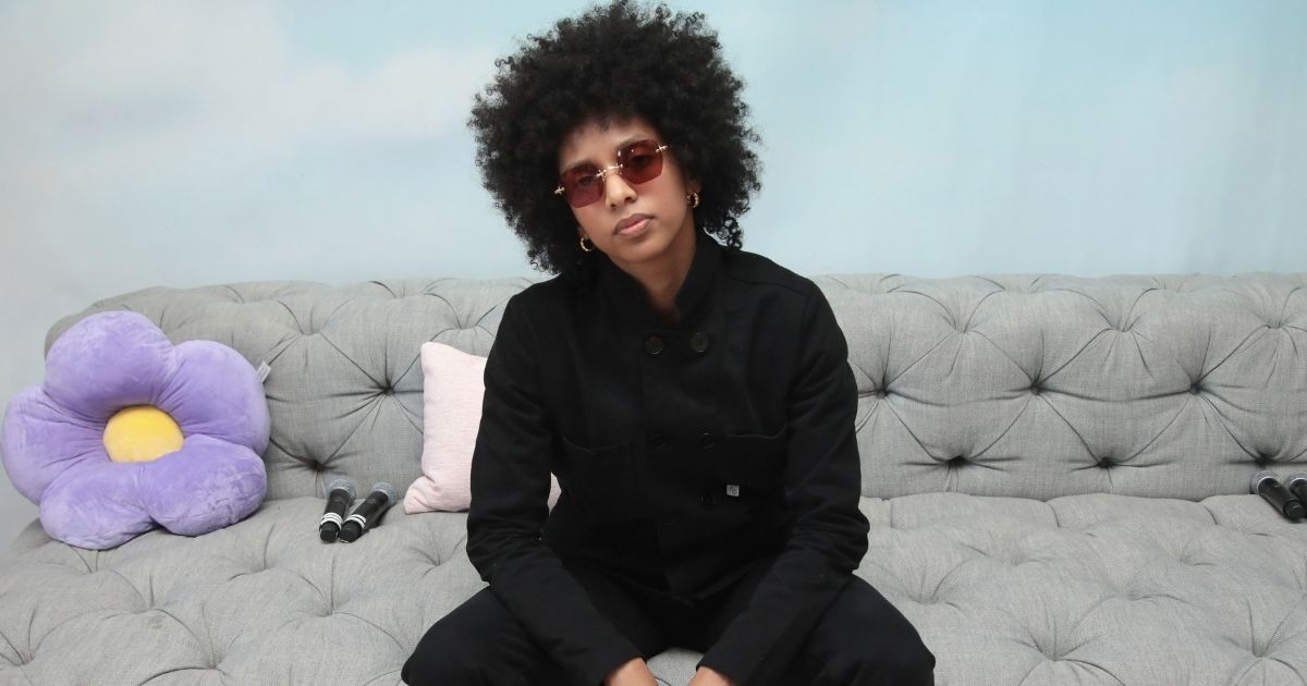 Co-founder of Black Lives Matter Toronto Janaya Khan poses sitting on a couch at the Gurls Talk Festival, sponsored in collaboration with Coach and Teen Vogue, in March 2018 in New York City.