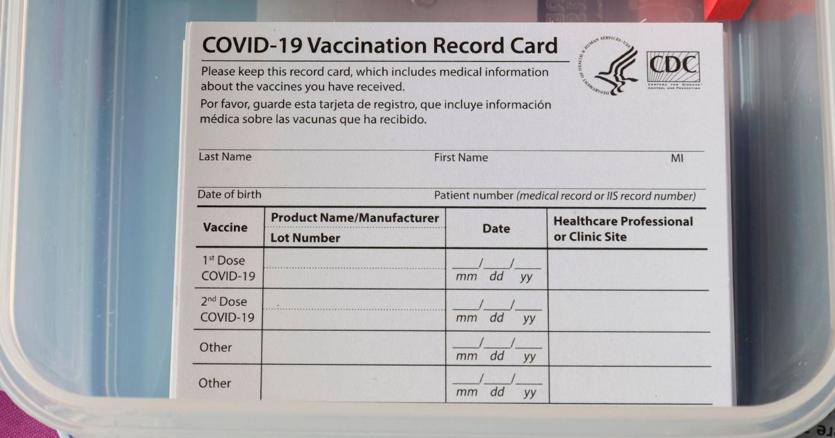 Blank COVID-19 vaccination cards and holders are stacked at a pop-up COVID-19 vaccination clinic at Larry Flynt's Hustler Club on Dec. 21, 2021, in Las Vegas.