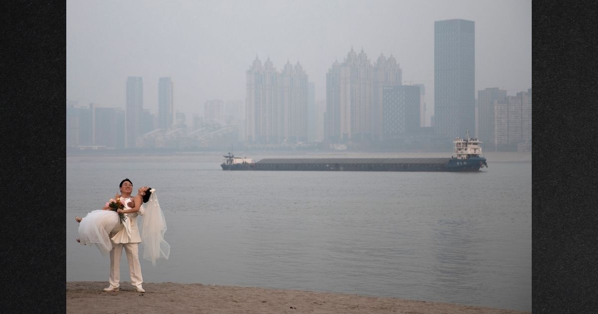 Newlyweds take wedding photos on a hazy day near the Yangtze River on Jan. 19 in Wuhan, China. Life for many of the residents in Wuhan is returning to normal two years after the city imposed strict lockdowns to reduce the spread of COVID-19. China will be marking the Spring Festival, which begins with the Lunar New Year, on Feb. 1, ushering in the Year of the Tiger.