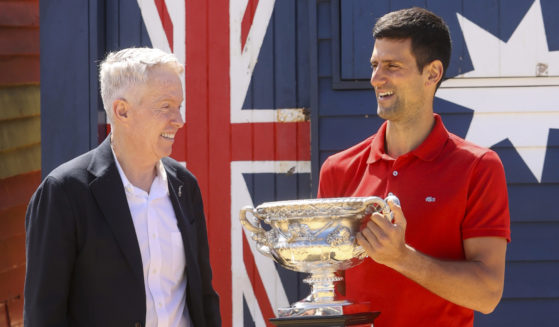 Serbia's Novak Djokovic, right, stands with Australian Open tournament director Craig Tiley following his win at the Australian Open in Melbourne, Australia, on Feb. 22, 2021.