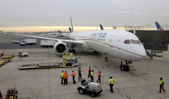 A Dreamliner 787-10 pulls up to a gate at Newark Liberty International Airport in Newark, N.J., in this file photo from January 2019. Federal safety officials say interference from the impending 5G wireless networks may create interference that could delay systems like thrust reversers on Boeing 787s from kicking in, leaving only the brakes to slow the plane.