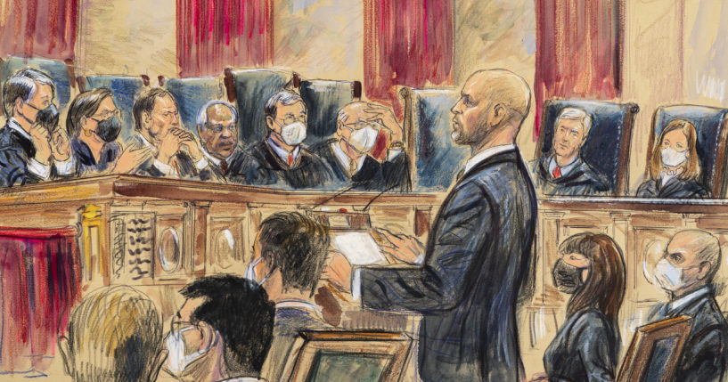 An artist's sketch depicts lawyer Scott Keller standing to argue on behalf of more than two dozen business groups opposing a Biden administration vaccine-or-testing mandate before the Supreme Court in Washington, D.C., on Jan. 7. The court has stopped the Biden administration from enforcing a requirement that employees at large businesses be vaccinated against COVID-19 or undergo weekly testing and wear a mask on the job.
