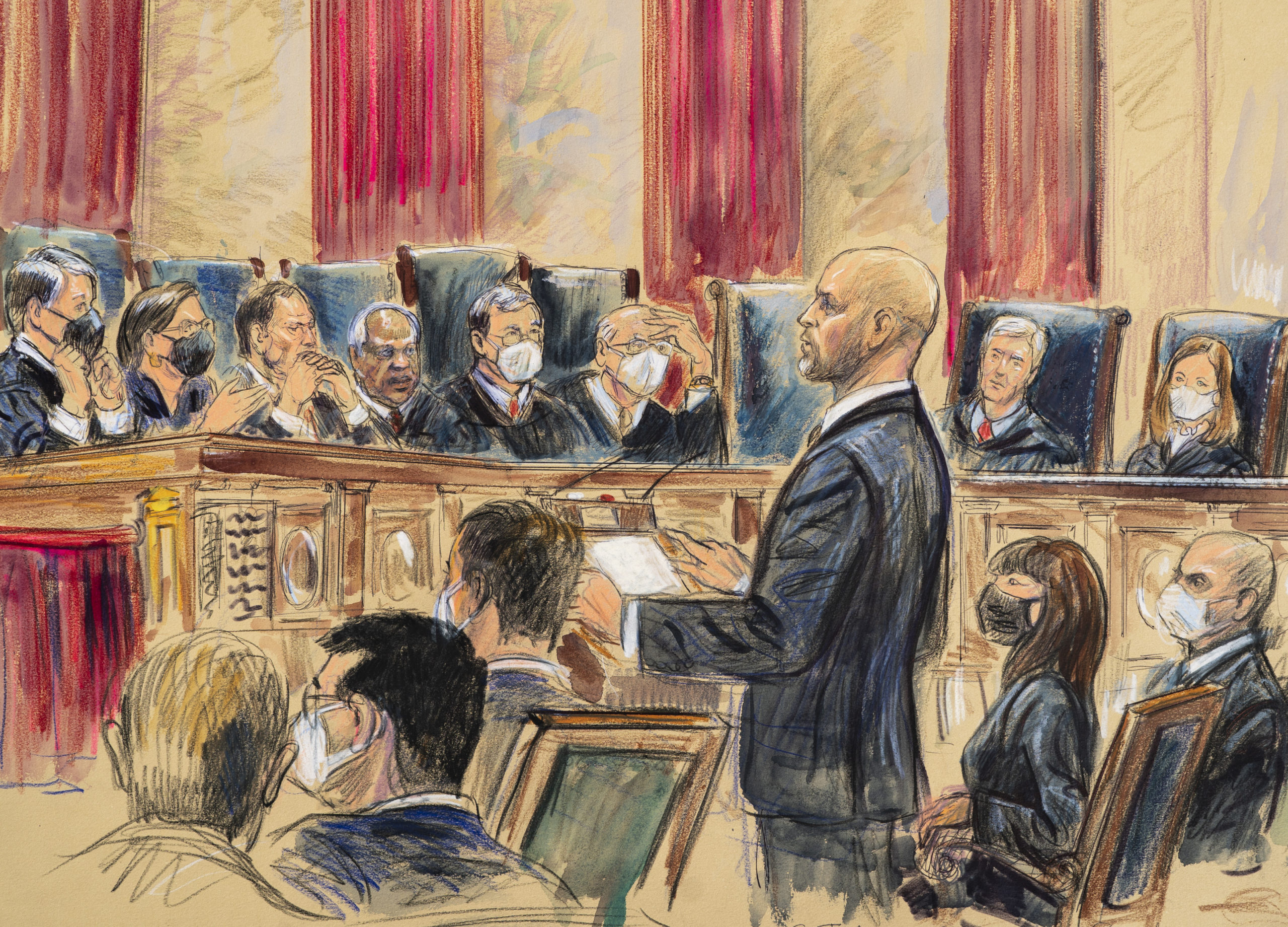 An artist's sketch depicts lawyer Scott Keller standing to argue on behalf of more than two dozen business groups opposing a Biden administration vaccine-or-testing mandate before the Supreme Court in Washington, D.C., on Jan. 7. The court has stopped the Biden administration from enforcing a requirement that employees at large businesses be vaccinated against COVID-19 or undergo weekly testing and wear a mask on the job.