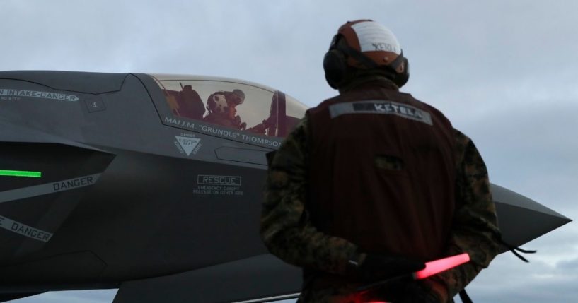 A Marine communicates with the pilot of an F-35 fighter jet aboard the amphibious assault ship USS Tripoli on Jan. 19.
