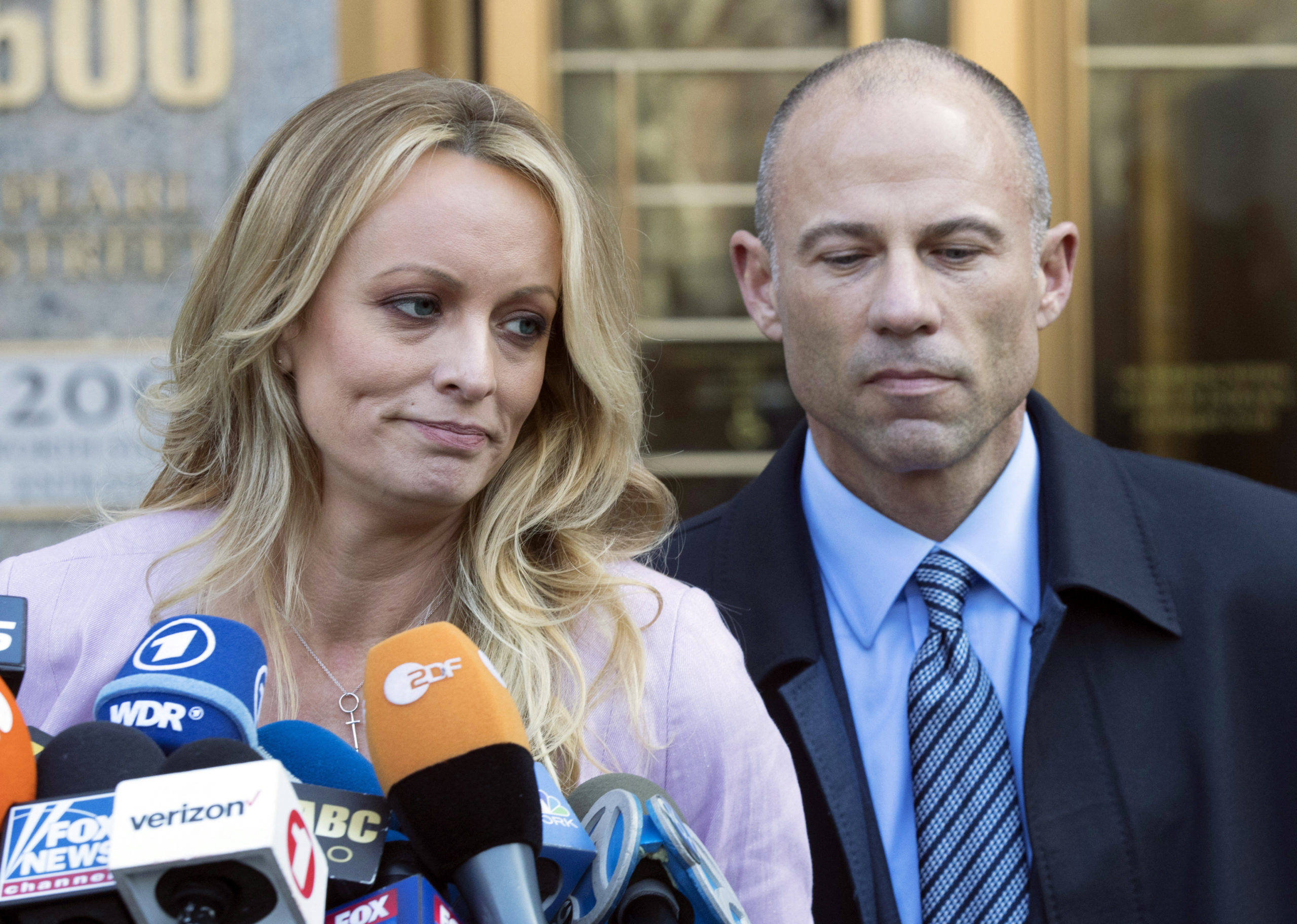 Porn actress Stormy Daniels, accompanied by her attorney, Michael Avenatti, talks to the media as she leaves federal court in New York on April 16, 2018. On Friday, Avenatti was convicted of charges he cheated Daniels out of nearly $300,000.