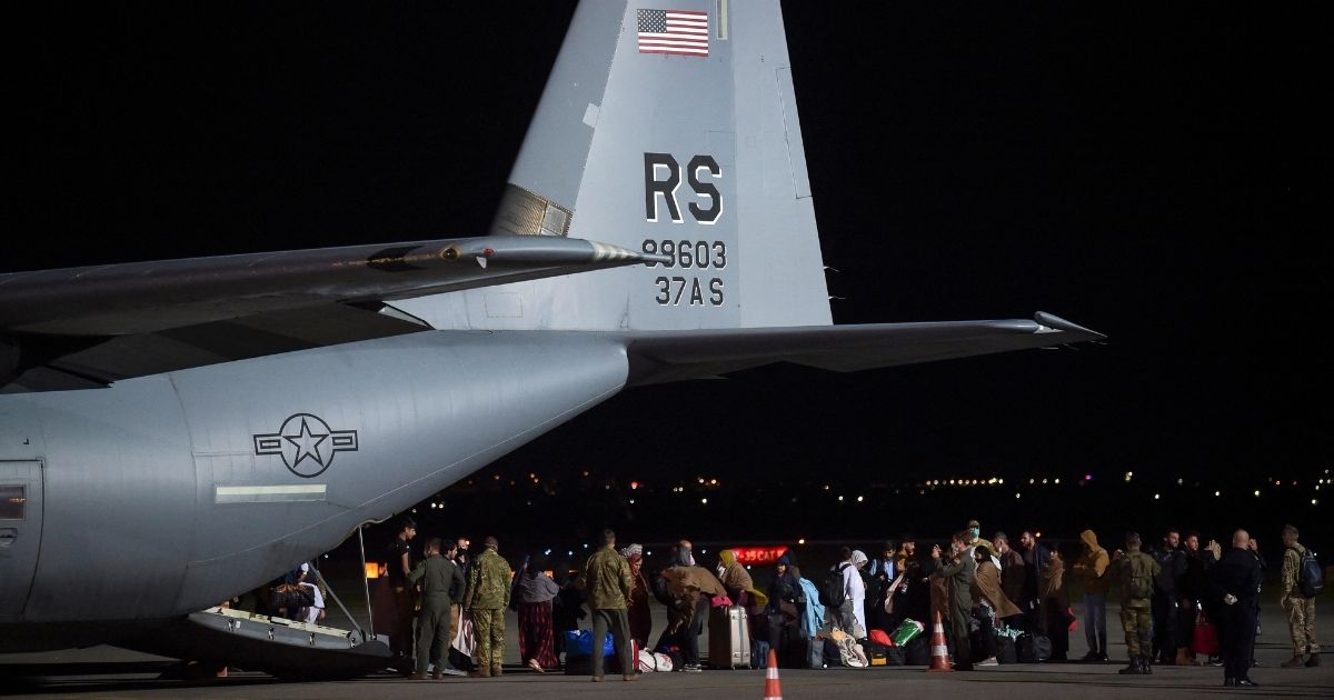 Afghan refugees exit a U.S. Air Force plane upon arrival at Pristina International Airport near Pristina, Kosovo, on Aug. 29, 2021.