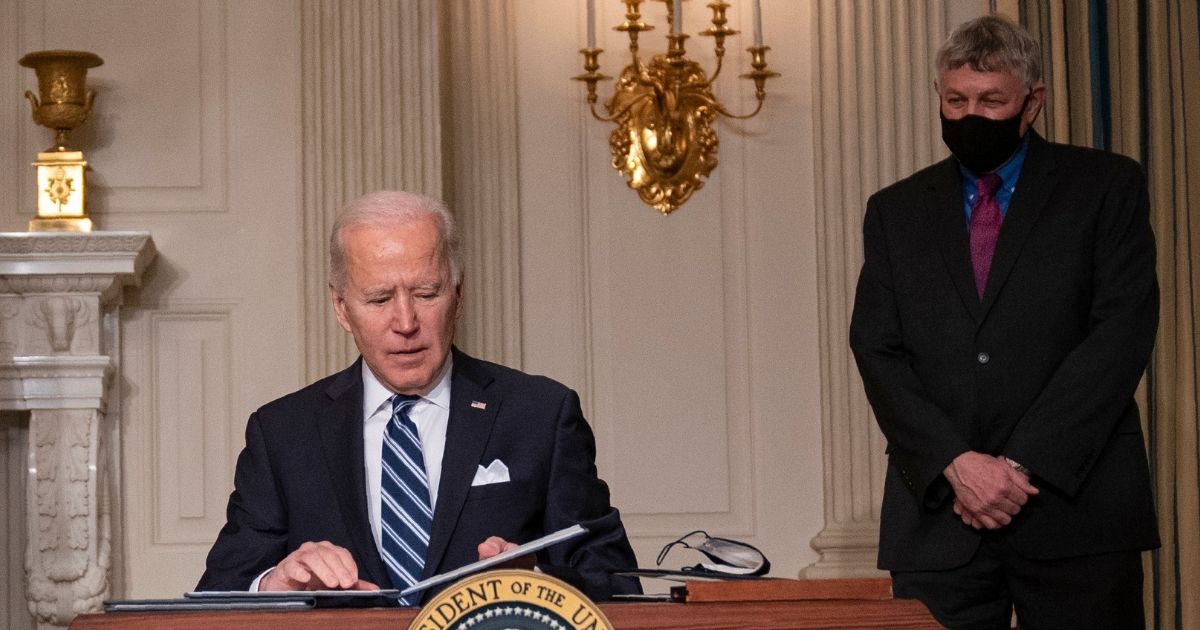 White House science adviser Eric Lander watches as President Joe Biden signs a series of executive orders on climate change in the State Dining Room of the White House in Washington on Jan. 27, 2021.