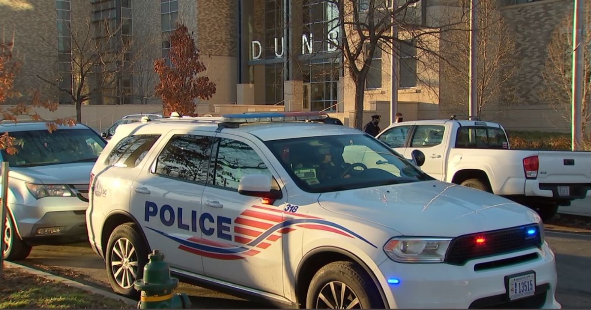 Police are parked outside of Dunbar High School in Washington, D.C., following a bomb threat.