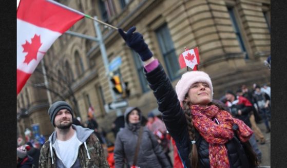 Supporters gather in Ottawa, Ontario, Feb. 17 to join a protest organized by Canadian truck drivers opposing vaccine mandates. Government officials are now planning to seize bank accounts of protest participants and supporters, and are using support of Donald Trump as one of their criteria to determine whether they will do so.