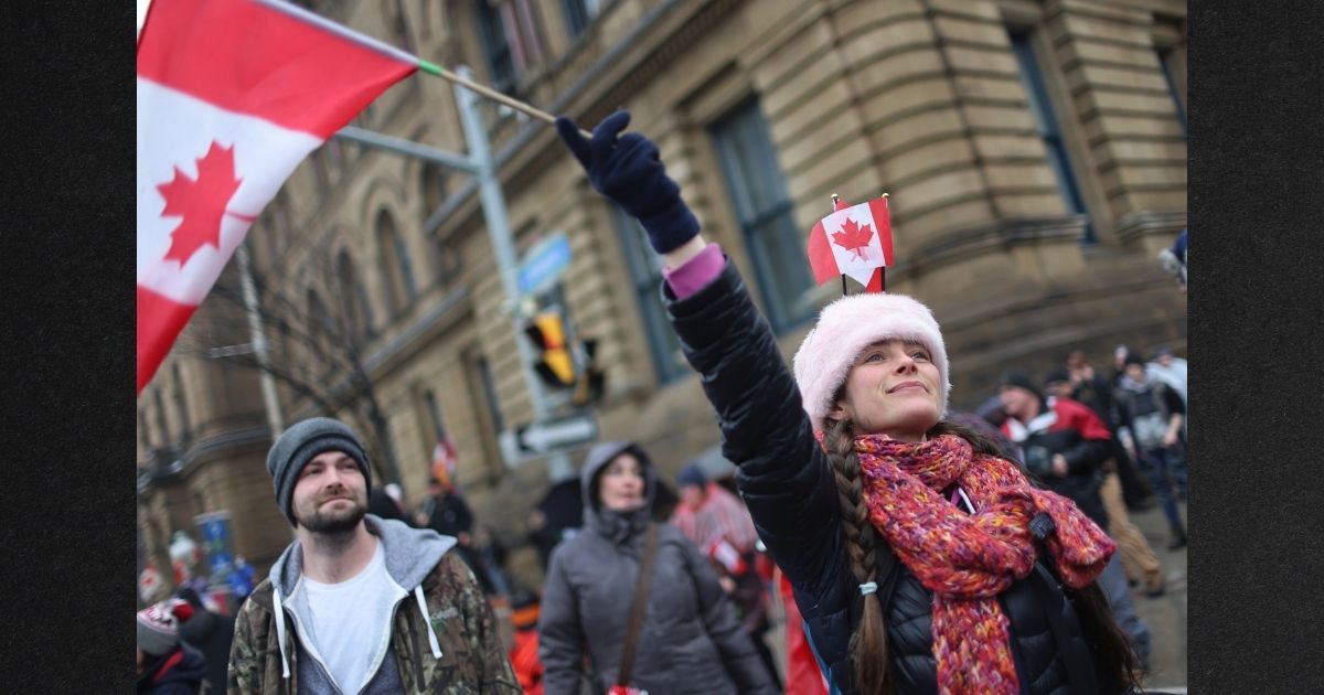 Supporters gather in Ottawa, Ontario, Feb. 17 to join a protest organized by Canadian truck drivers opposing vaccine mandates. Government officials are now planning to seize bank accounts of protest participants and supporters, and are using support of Donald Trump as one of their criteria to determine whether they will do so.