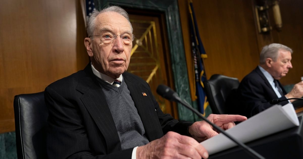 Republican Sen. Chuck Grassley of Iowa gets ready before a meeting in the Capitol to advance President Joe Biden's nominees to the federal courts on Feb. 17.
