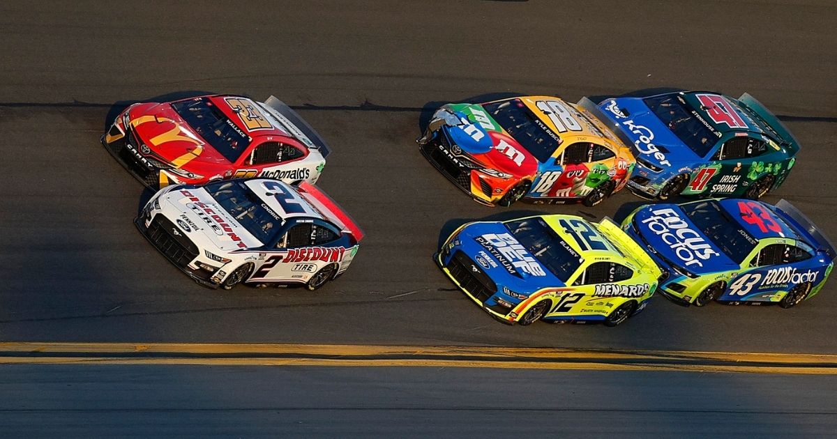 Austin Cindric, driver of the #2 Discount Tire Ford, Bubba Wallace, driver of the #23 McDonald's Toyota, Ryan Blaney, driver of the #12 Menards/Blue DEF/PEAK Ford, Kyle Busch, driver of the #18 M&M's Toyota, Erik Jones, driver of the #43 FOCUSfactor Chevrolet, and Ricky Stenhouse Jr., driver of the #47 Kroger/Irish Spring Chevrolet, race during the NASCAR Cup Series 64th Annual Daytona 500 at Daytona International Speedway on Sunday in Daytona Beach, Florida.