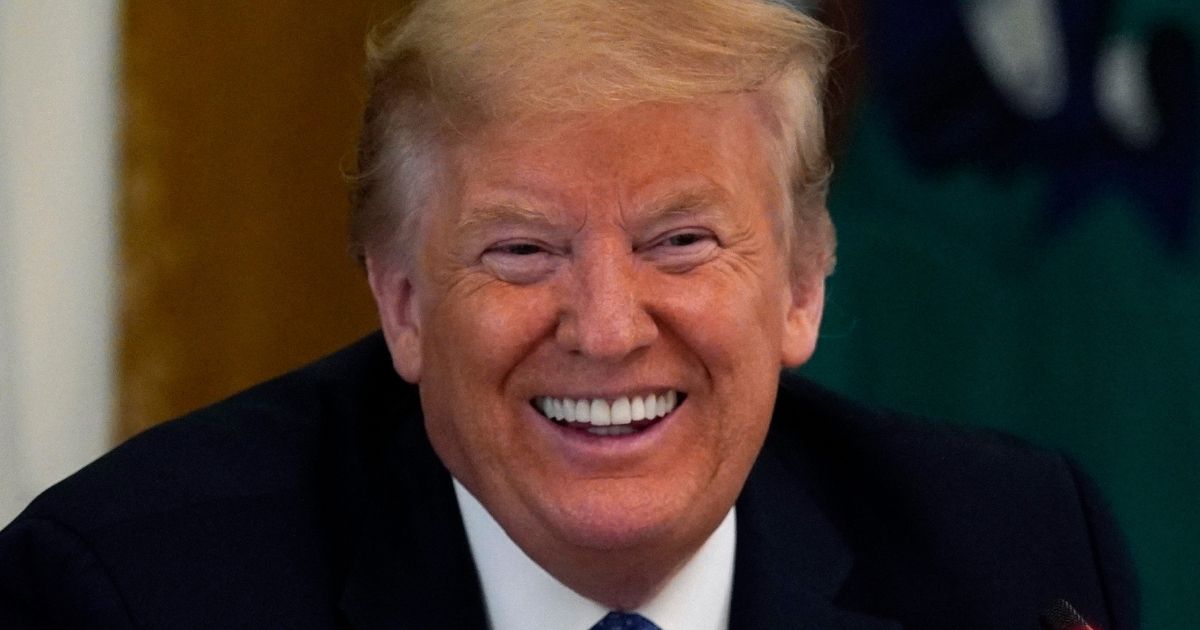 Then-President Donald Trump smiles during a Cabinet Meeting in the East Room of the White House in Washington on May 19, 2020.
