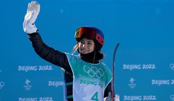 Eileen Gu, an American-born skier who is competing for China in the 2022 Beijing Winter Olympics, waves after competing in the women's freestyle skiing big air finals on Tuesday.