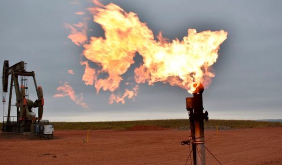 A flare burns natural gas at an oil well in Watford City, N.D., in this file photo from August 2021. The Biden administration has halted oil and gas leases on federal land, making the US even more dependent on foreign oil as prices skyrocket in response to Russia's invasion of Ukraine.