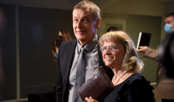 Päivi Räsänen, a member of Finland's Parliament, right, holds a Bible as she arrives with her husband Niilo Räsänen for her trial in Helsinki on Jan. 24. The former interior minister and Christian Democrats leader is facing charges of incitement against a minority group for criticism of a church's participation in a 'gay pride' event and for posting a photo of a Bible verse on social media.