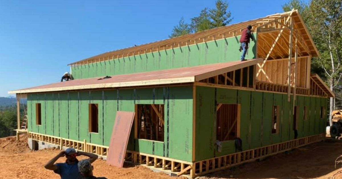 Workers help build a new home large enough to house sibling groups of foster children.