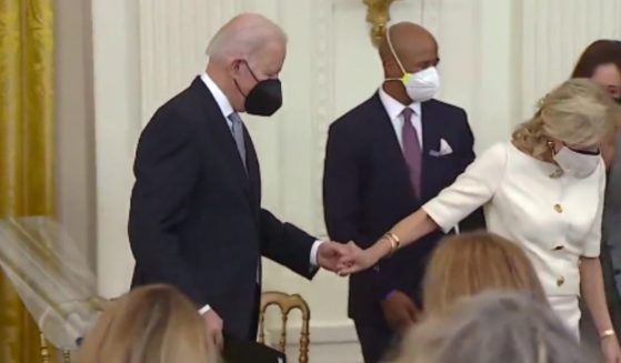 Social media was abuzz after a short clip made the rounds showing first lady Jill Biden leading President Joe Biden by the hand as he shuffled down a few stairs.