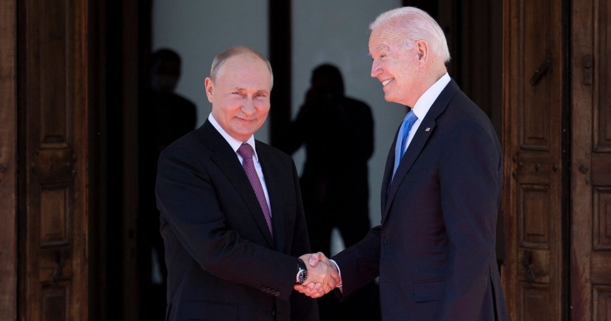 Russian President Vladimir Putin, left, shakes hands with U.S. President Joe Biden prior to a summit in Geneva on June 16, 2021.