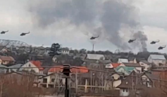 Russian military helicopters fly over the outskirts of Kyiv, Ukraine, on Thursday morning after Russia began their anticipated attack on the country.