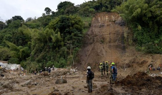 Rescuers search for victims after a landslide caused by heavy rains in Pereira, Colombia, on Feb. 8. At least 15 people were confirmed died and 35 were injured in a mudslide triggered by heavy rains.