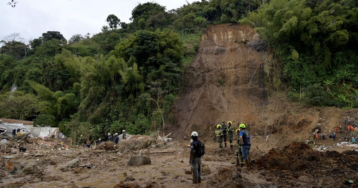Rescuers search for victims after a landslide caused by heavy rains in Pereira, Colombia, on Feb. 8. At least 15 people were confirmed died and 35 were injured in a mudslide triggered by heavy rains.