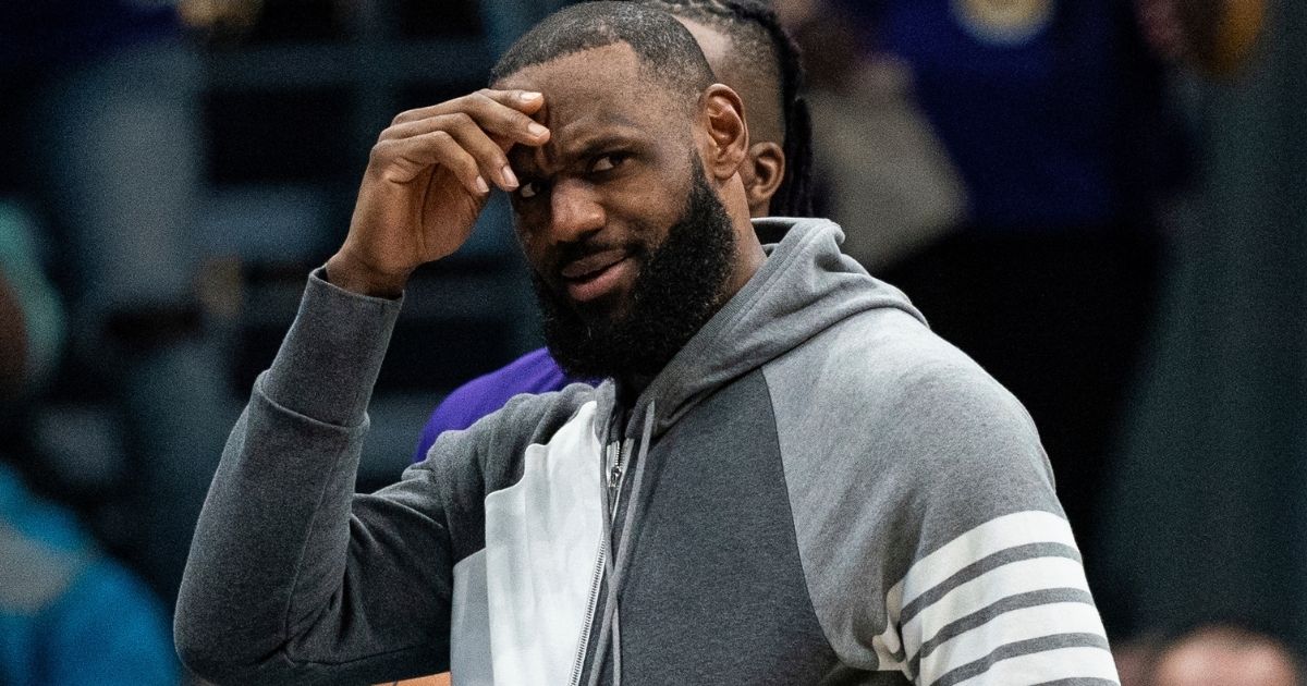 LeBron James, a forward for the Los Angeles Lakers, watches the first half of the game against the Charlotte Hornets in Charlotte, North Carolina, on Jan. 28.