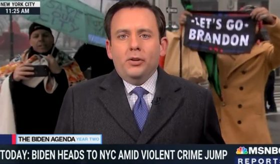 A banner reading "Let's go Brandon" is displayed in the background of an MSNBC segment on President Joe Biden's visit to New York.