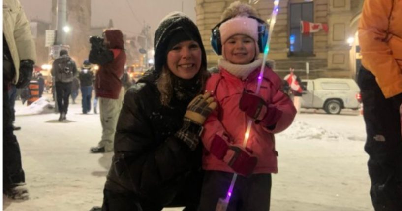 Canadian Freedom Convoy organizer Tamara Lich, pictured with a child identified as her daughter, was denied bail by a judge who feared she would re-offend.