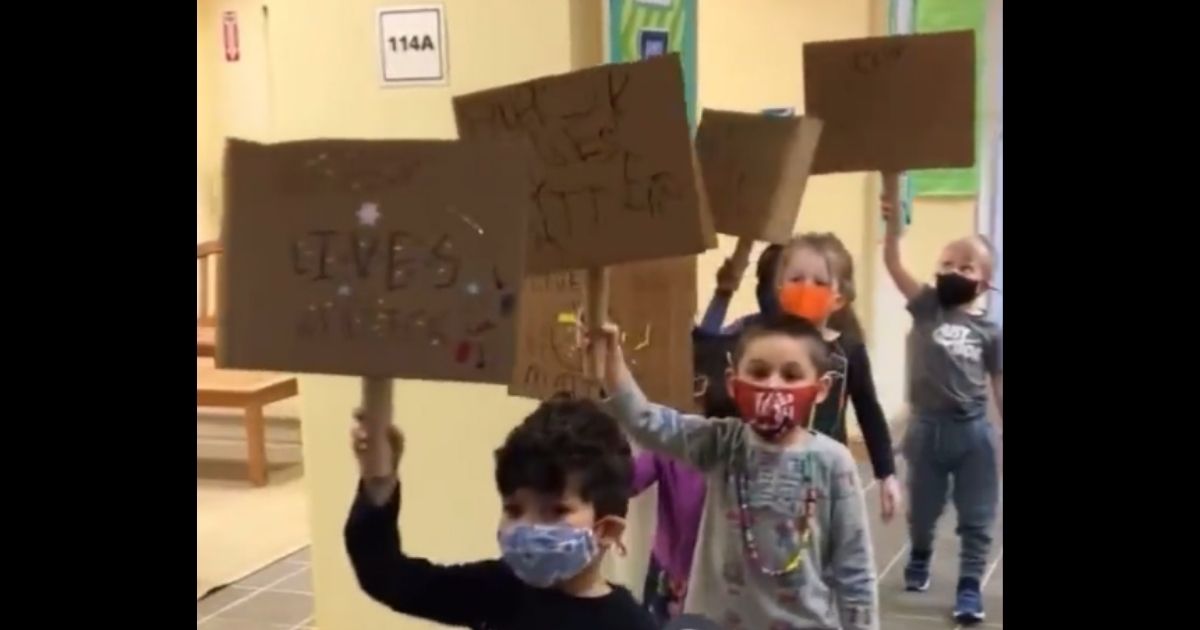 Children at the Lowell School in Washington hold "Black Lives Matter" signs.