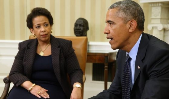 Then-President Barack Obama and his attorney general, Loretta Lynch, talk to reporters in the Oval Office of the White House in Washington on May 29, 2015.