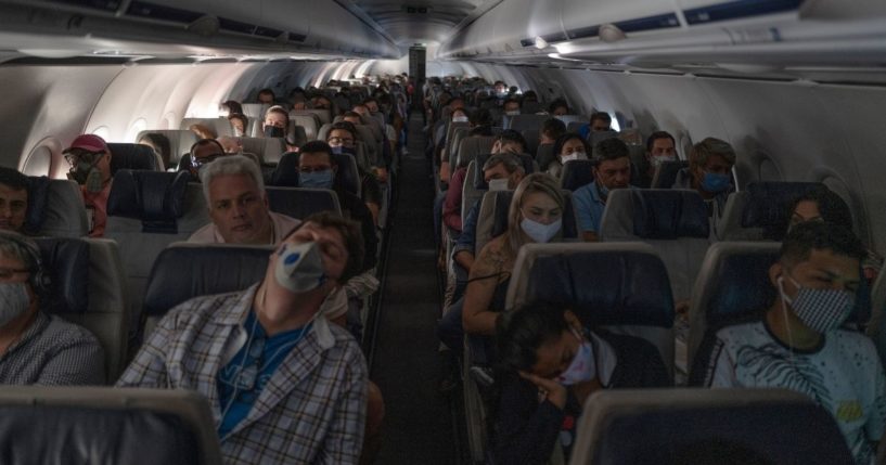 Most passengers wear face masks for COVID-19 protection on a flight from Manaus, Brazil, to Sao Paulo on May 30, 2020.