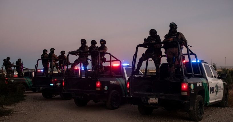 A group of Mexican police set up in Ciudad Acuna, Mexico, on Sept. 23, 2021, near the border of Del Rio, Texas.