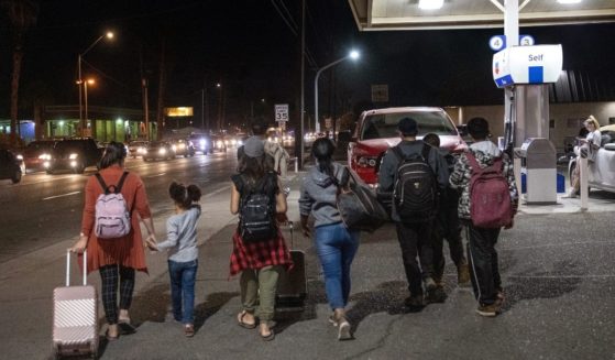 Immigrants walk from the U.S.-Mexico border into the city of Yuma, Arizona, on Dec. 8.