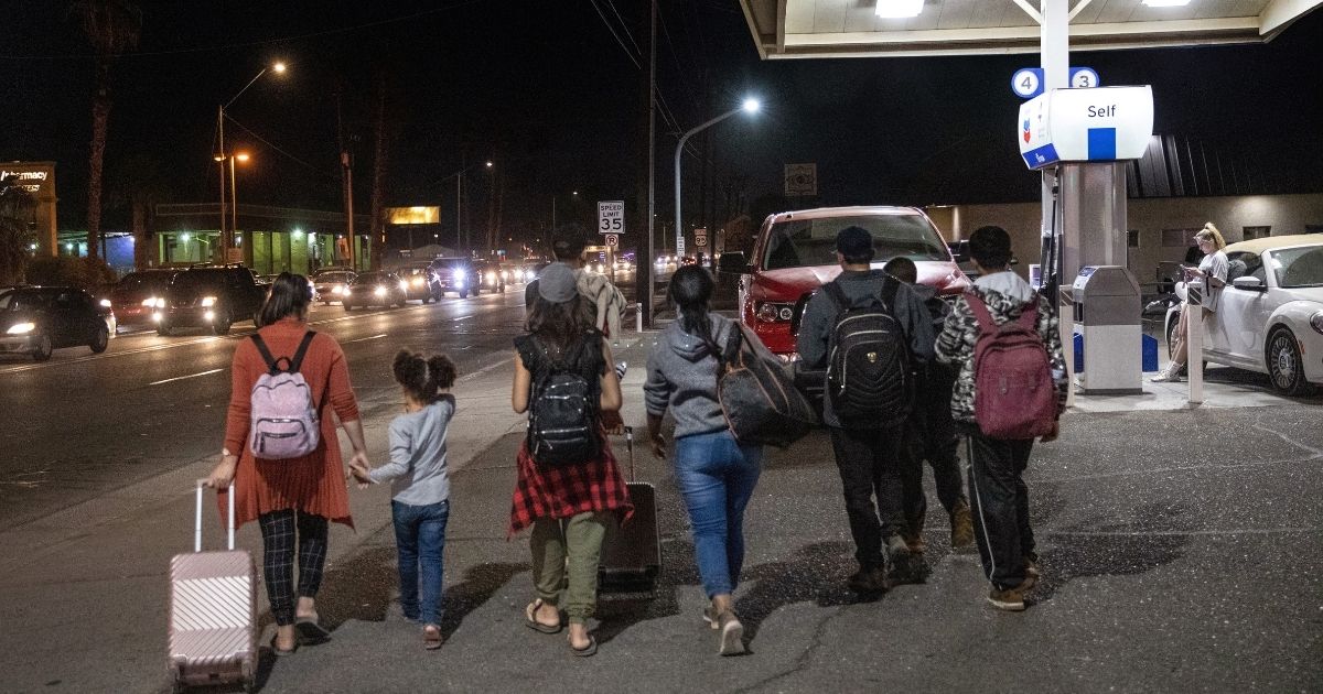 Immigrants walk from the U.S.-Mexico border into the city of Yuma, Arizona, on Dec. 8.
