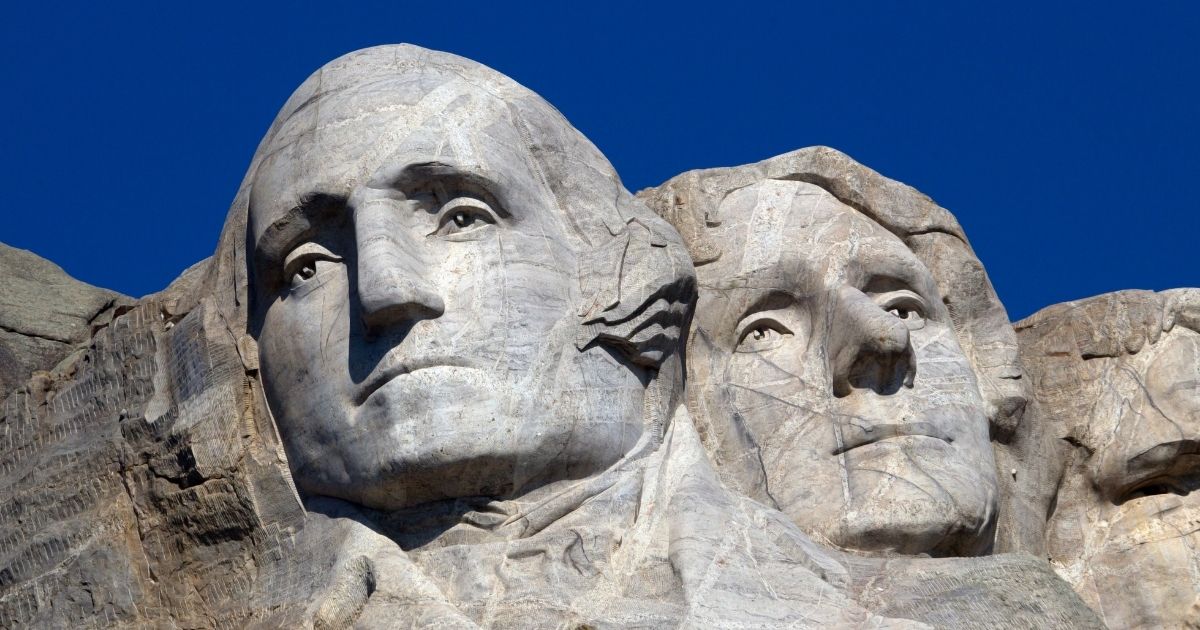 Images of Founding Fathers George Washington and Thomas Jefferson are carved in granite at Mount Rushmore National Memorial in South Dakota.