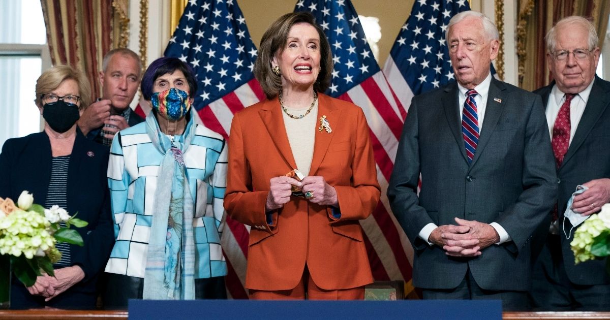 Speaker of the House Nancy Pelosi, center, stands with House Democratic representatives - from left to right Chellie Pingree of Maine, Sean Maloney of New York, Rosa DeLauro of Connecticut, Steny Hoyer of Maryland, and David Price of North Carolina - during an enrollment ceremony for continued government funding on Dec. 3, 2021.