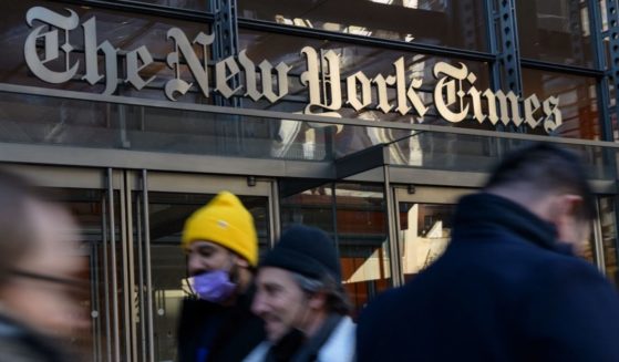 People walk by the New York Times Building in New York City on Feb. 1.